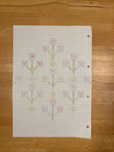 Needlepoint chart drawn on graph paper with coloured pencils